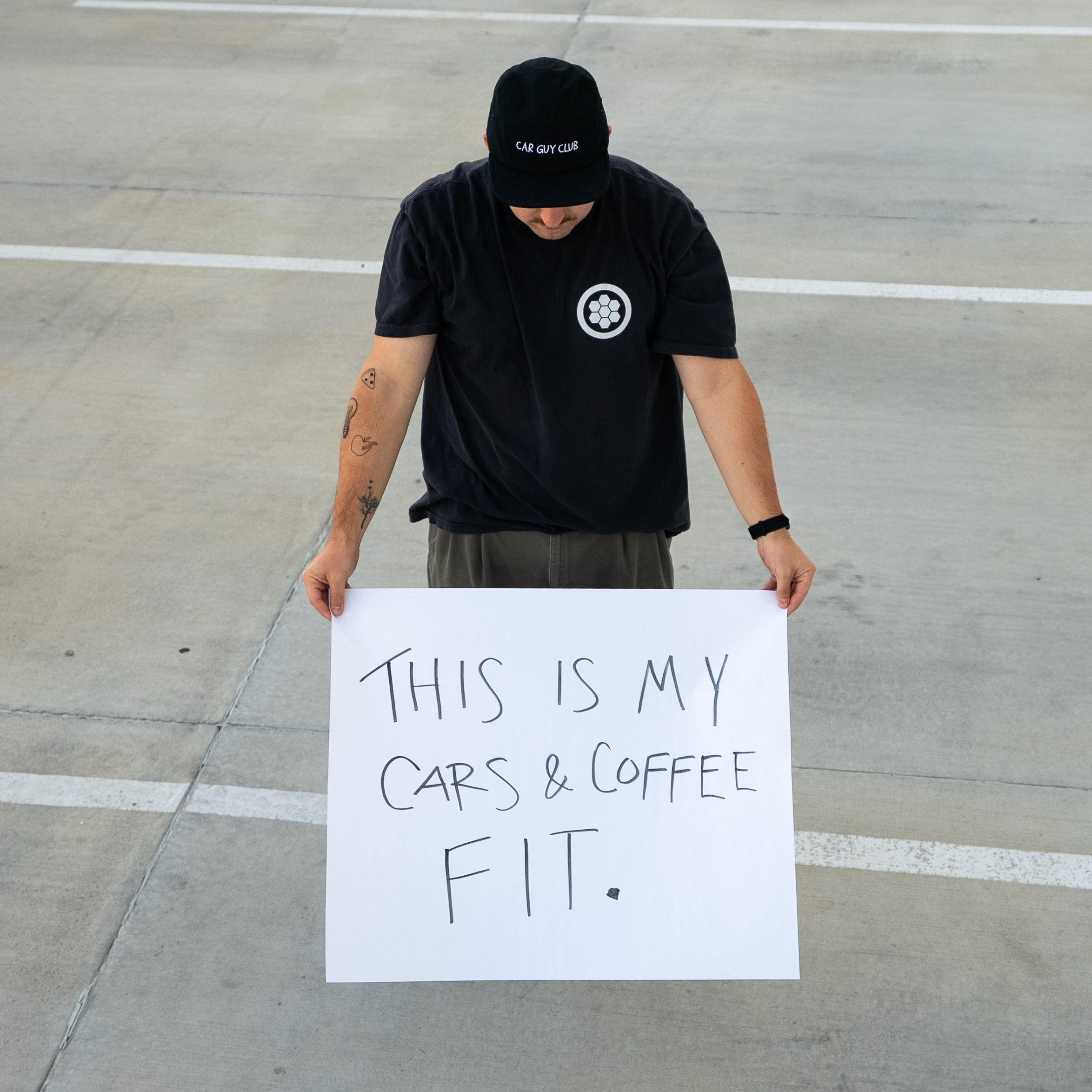 Person holding a sign on a concrete surface